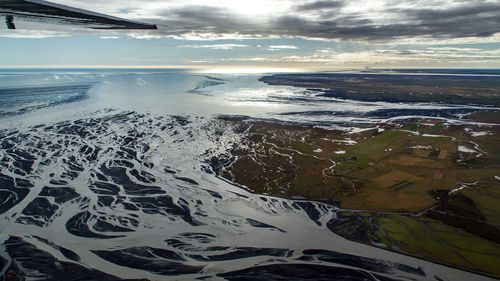 Aerial view of glacier riverbeds reaching the southern coast
